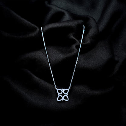 Silver necklace with a butterfly pendant on a black satin background