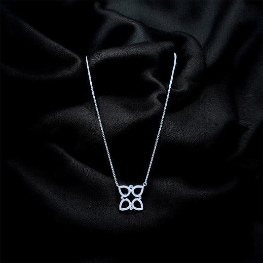 Silver necklace with a butterfly pendant on a black satin background