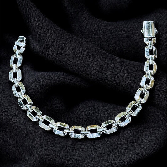 Silver chain bracelet on a black fabric background