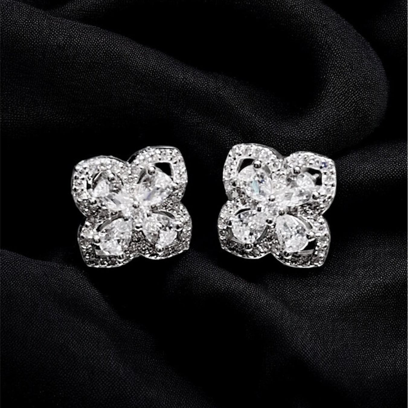 Diamond earrings on a black fabric background