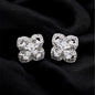 Diamond earrings on a black fabric background