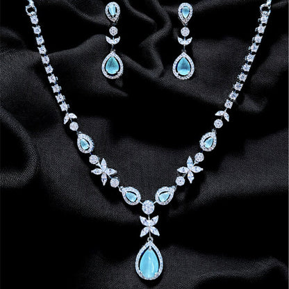 Jewelry set with necklace and earrings on a dark fabric background