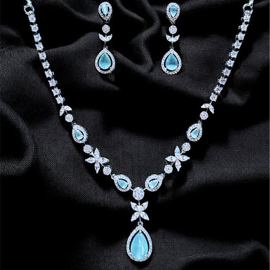 Jewelry set with necklace and earrings on a dark fabric background