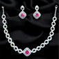Jewelry set with necklace and earrings featuring pink gemstones on a black background