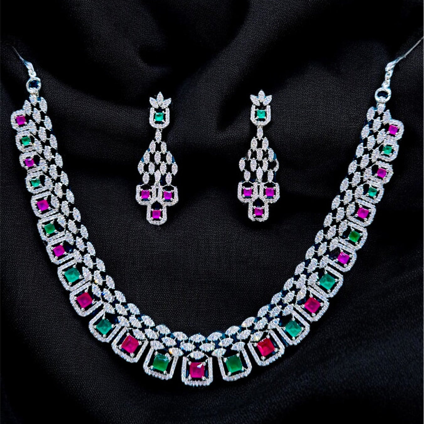 Jewelry set with necklace and earrings on a black fabric background