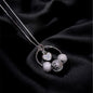 Silver necklace with spherical pendants on a black fabric background