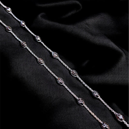 Close-up of a black fabric with silver beaded chain