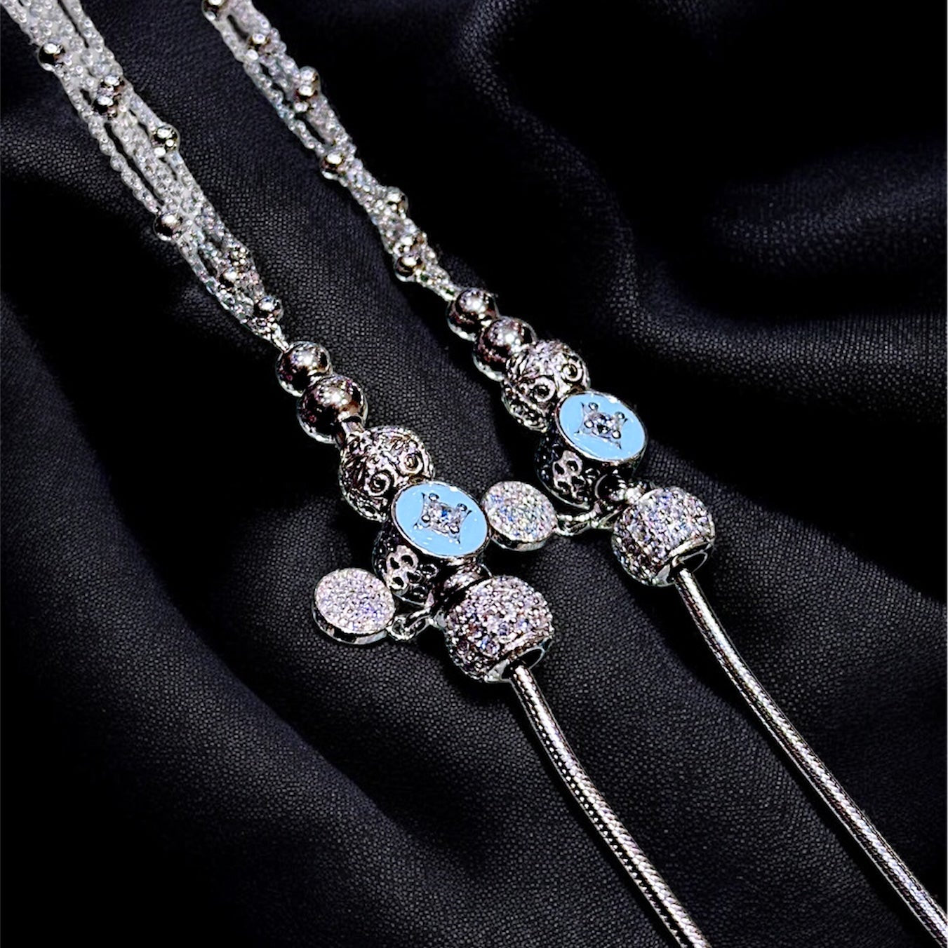 Decorative hairpin with blue gemstones on a black fabric background