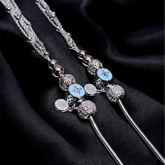 Decorative hairpin with blue gemstones on a black fabric background