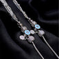 Decorative hairpin with blue gemstones on a black fabric background