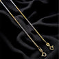 Two gold necklaces on a black fabric background