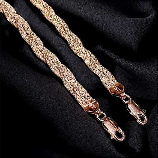Gold braided strap on a black fabric background