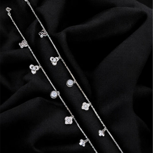 Silver bracelet with small diamonds on a black fabric background