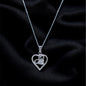 Silver necklace with a heart-shaped pendant on a black fabric background