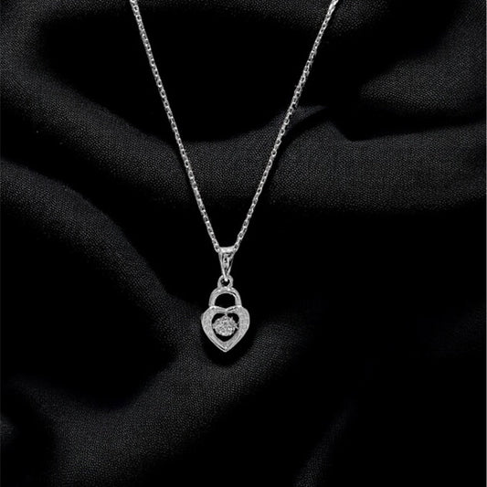 Silver necklace with a heart-shaped pendant on a black fabric background